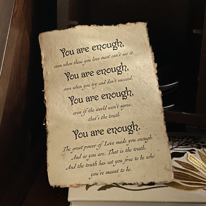 Vintage-style paper with motivational text on a dark background